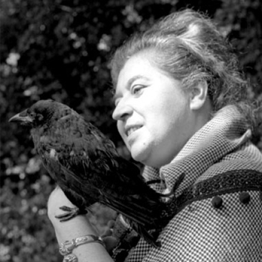 a practical-looking older woman holds a crow