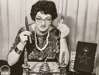 a woman from the 1960s with elegant glasses and hair holds up witchcraft tools