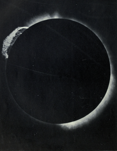 a black photo of a solar eclipse, with a disc faintly visible